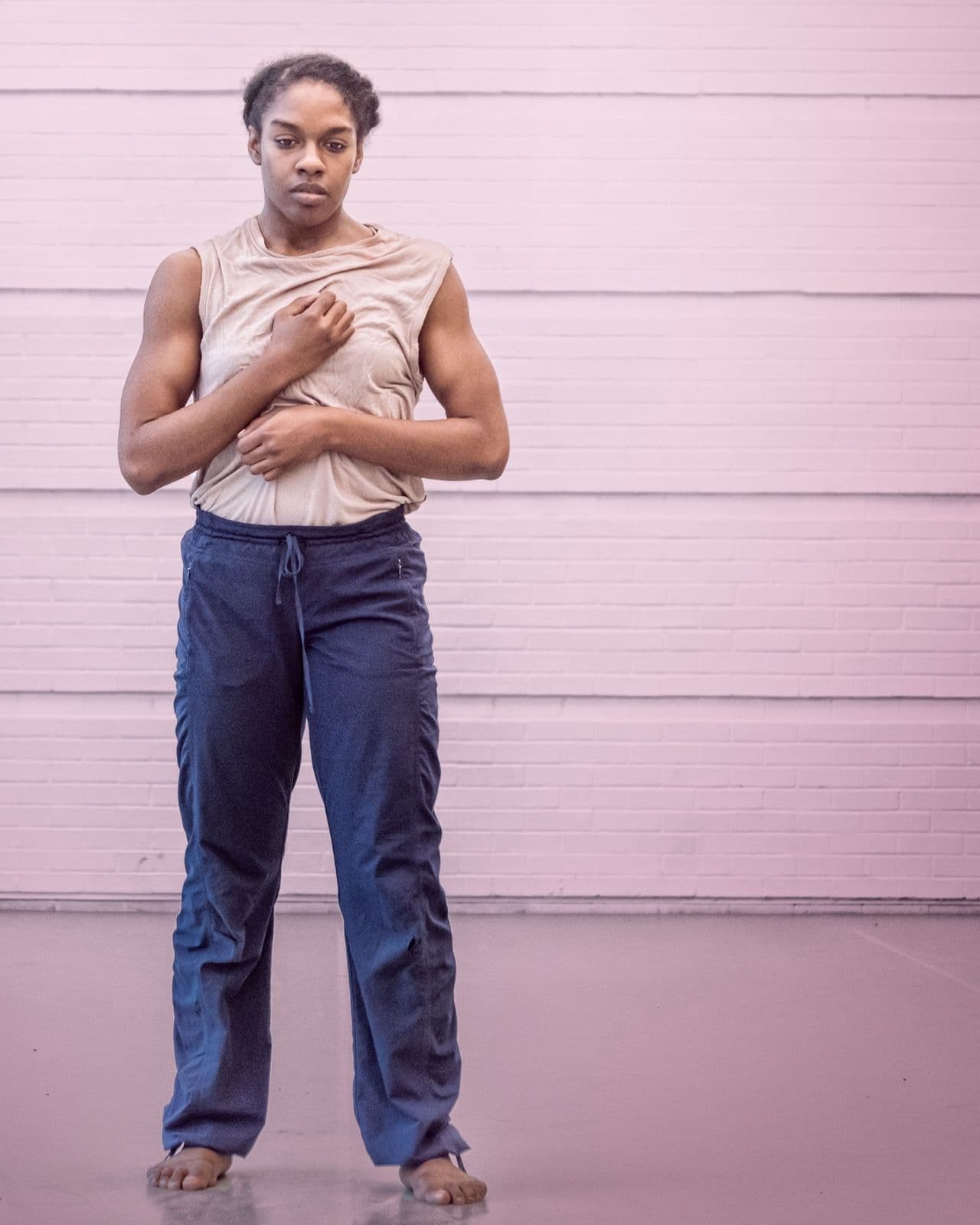 Full-length shot of dancer Kayla Farrish standing upright, looking forward in athletic wear.