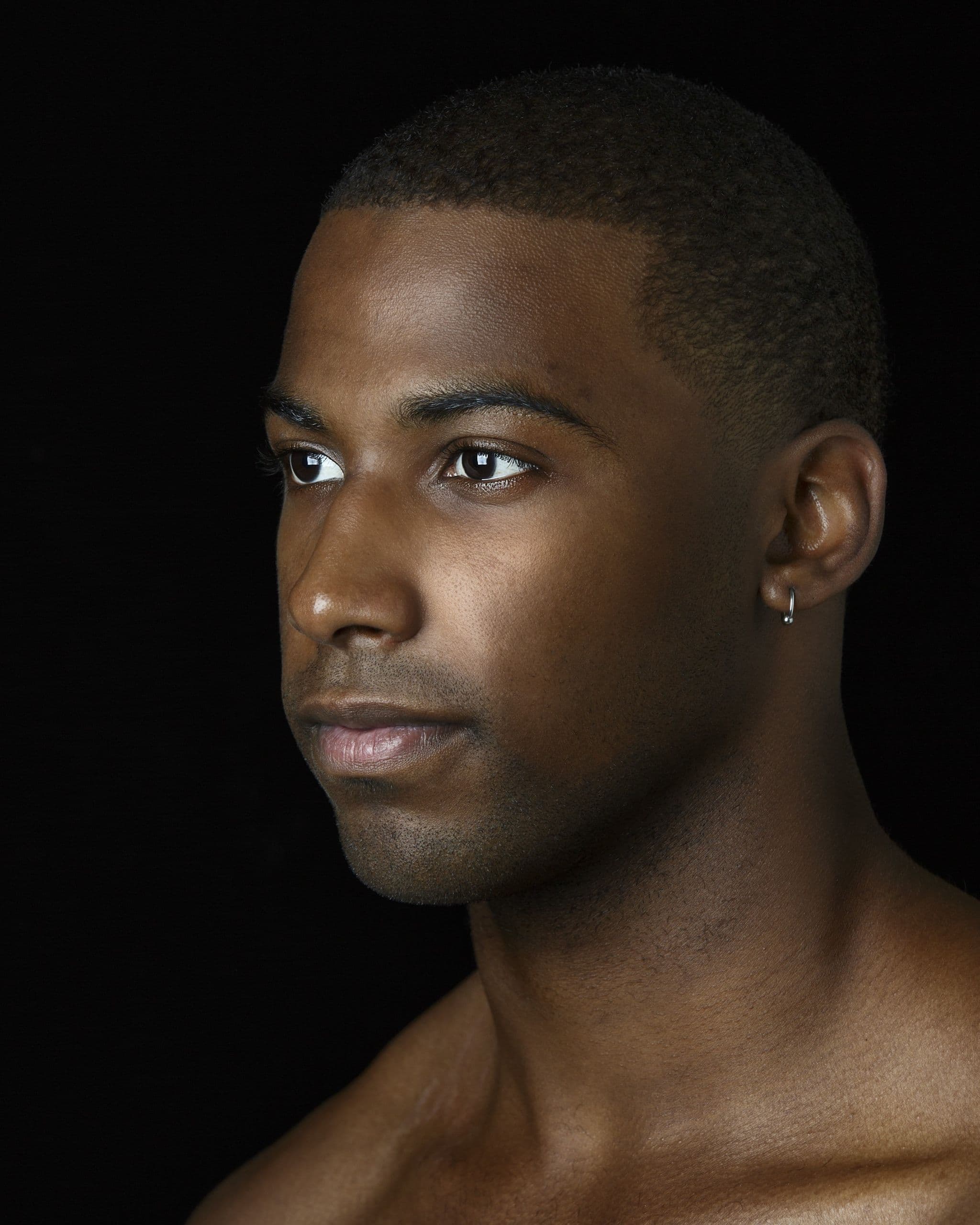 Headshot of Claude "CJ" Johnson against a black background