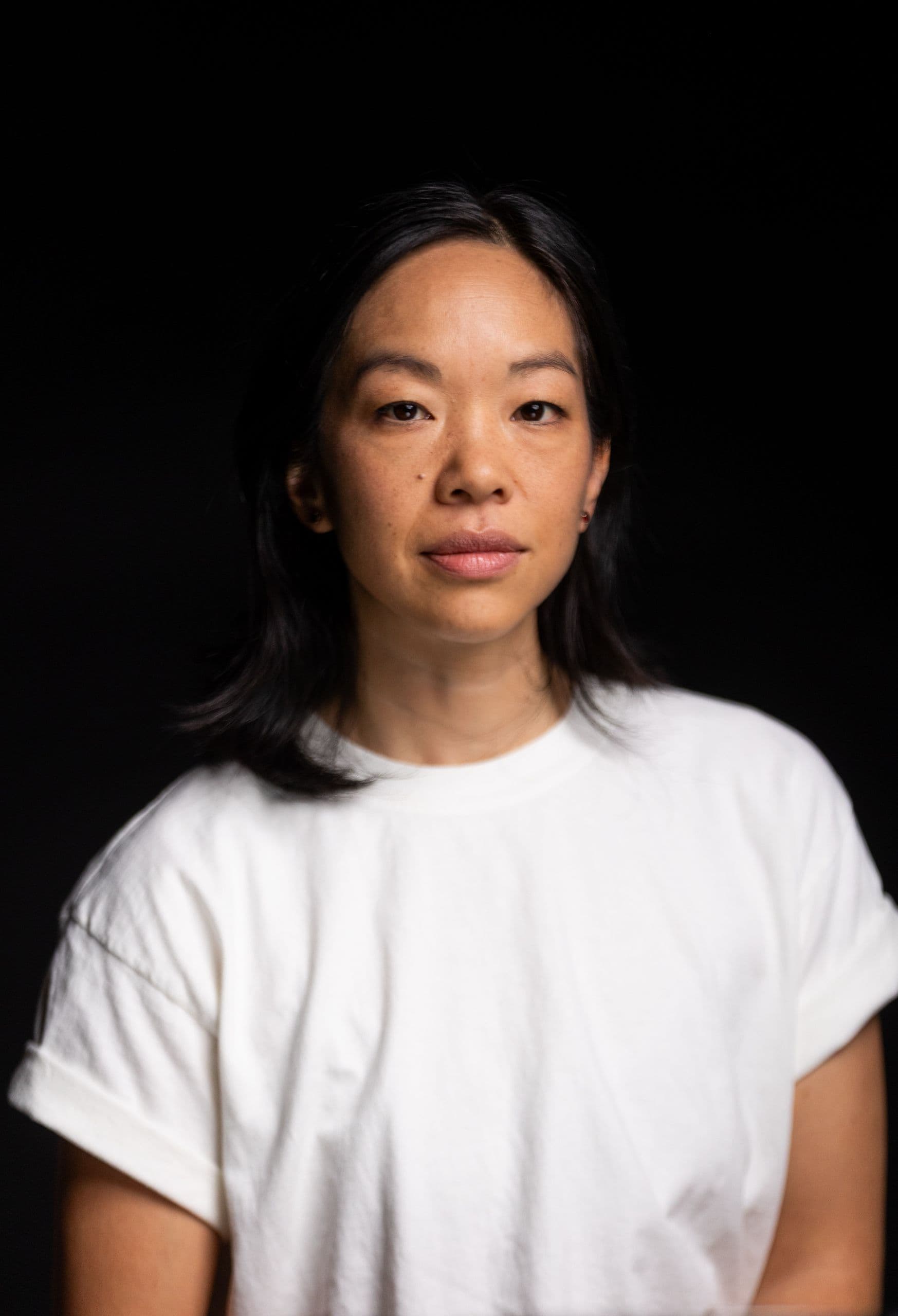 Jessica Tong stands in front of a black backdrop.